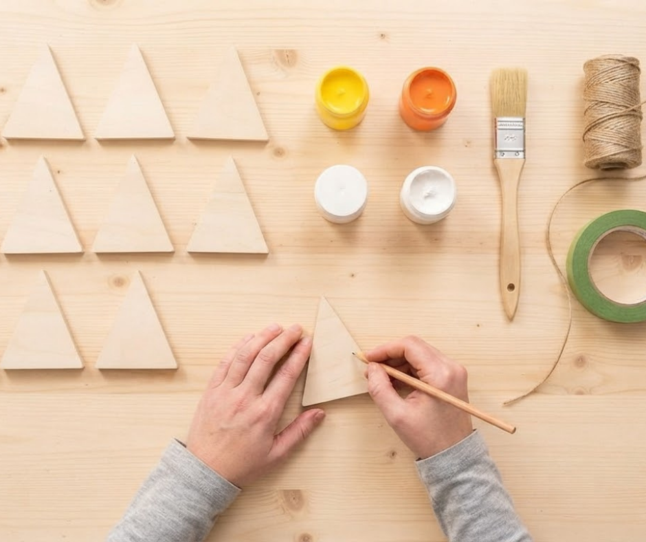 Learn how to make a DIY Candy Corn Garland from scrap wood, paint and twine. This easy fall decoration can be customized for fall or Halloween.