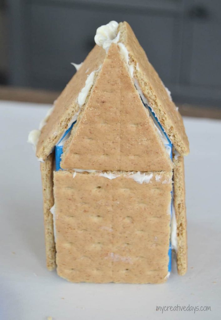 Are you looking for an easy way to make a Gingerbread House? Look no further! I found the easiest way to make a Gingerbread House that the kids can even do!