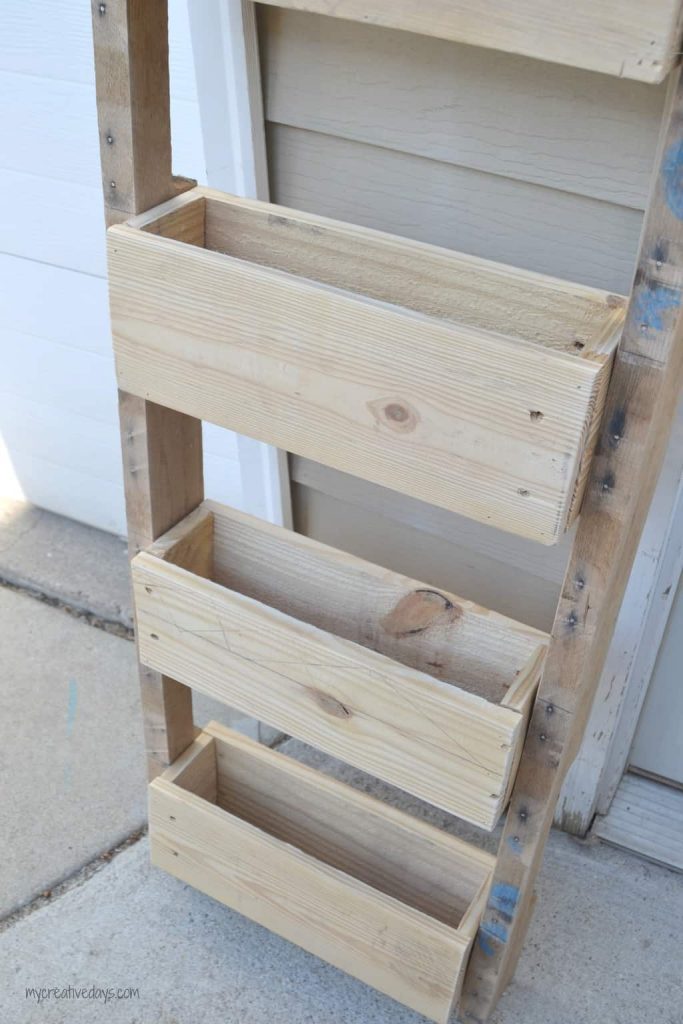 This Reclaimed Pallet Wood Organizer is easy to make and can be used to organize all kinds of things in your home.