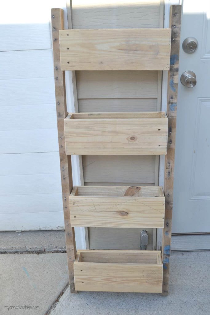 This Reclaimed Pallet Wood Organizer is easy to make and can be used to organize all kinds of things in your home.