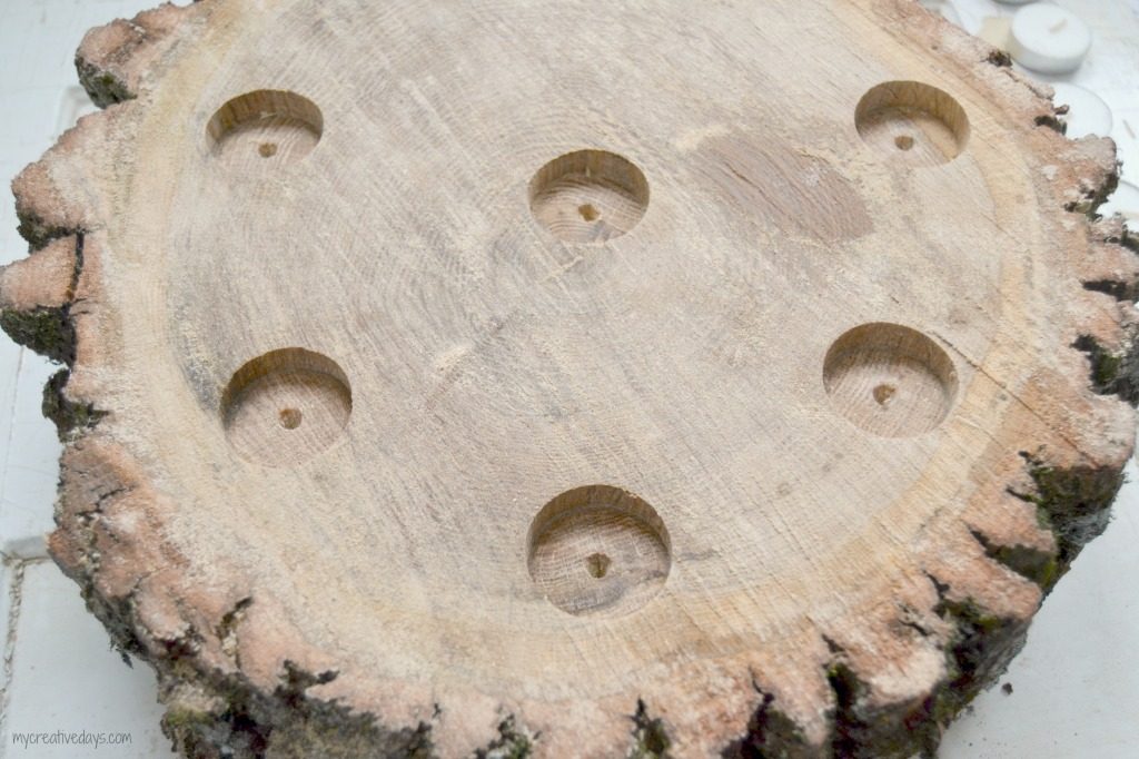 Do you like the look of rustic wood? This DIY Wood Slice Centerpiece is rustic and adds a beautiful statement wherever you place it.