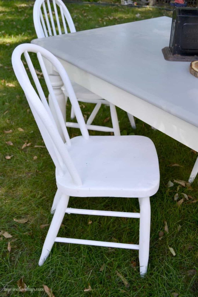 Are you looking for a farmhouse kitchen table and chairs? Search local yard sales and customize a set like we did with this one.