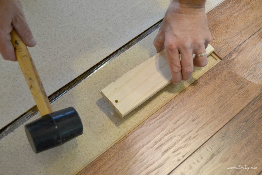 Do you want to put in new flooring in your home without hiring help? We are sharing how to install laminate flooring in your home the easy way. 