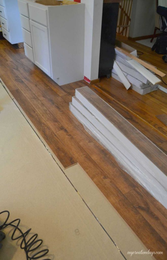 Do you want to put in new flooring in your home without hiring help? We are sharing how to install laminate flooring in your home the easy way. 