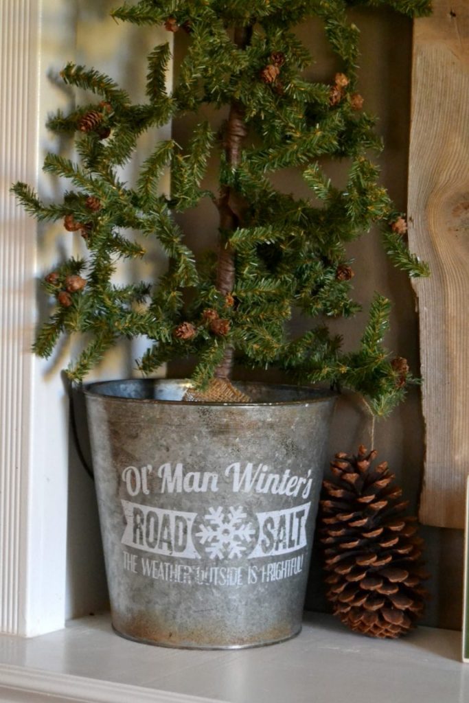 Decorating A Christmas Mantel does not have to be hard. Click over to see how to put together an easy and rustic Christmas mantel in no time. 