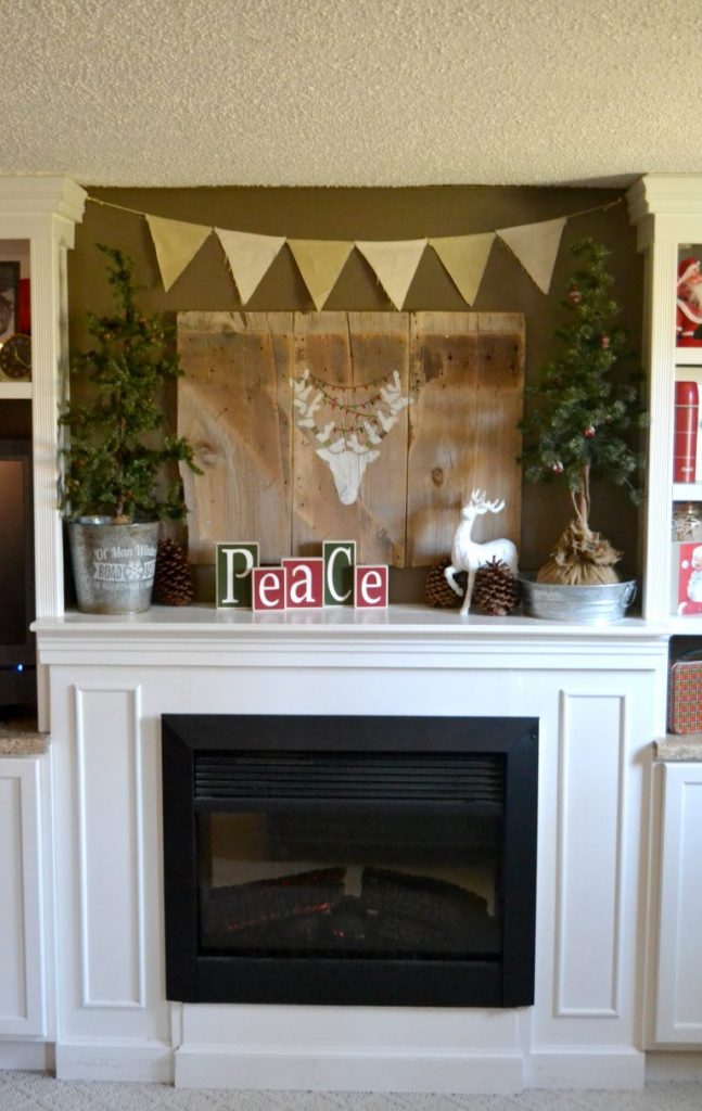 Decorating A Christmas Mantel does not have to be hard. Click over to see how to put together an easy and rustic Christmas mantel in no time. 