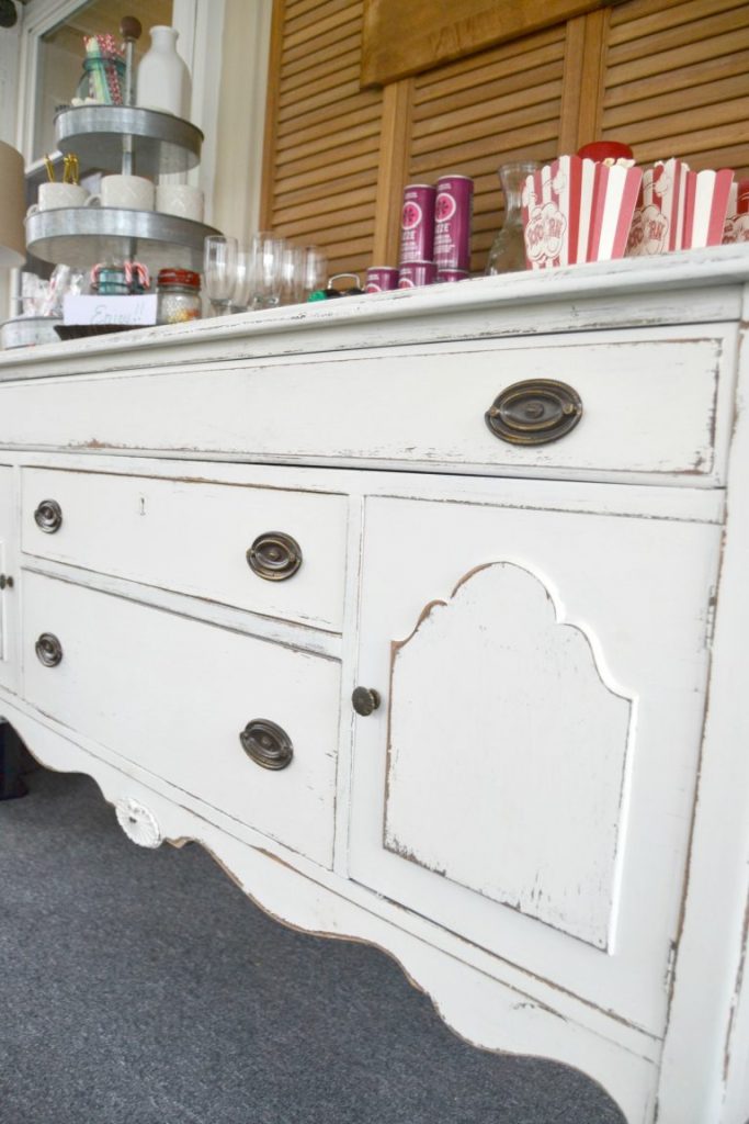 If you have an antique buffet that is in need of a makeover, click over to see how easy it was to transform this antique buffet into a white distressed show stopper!