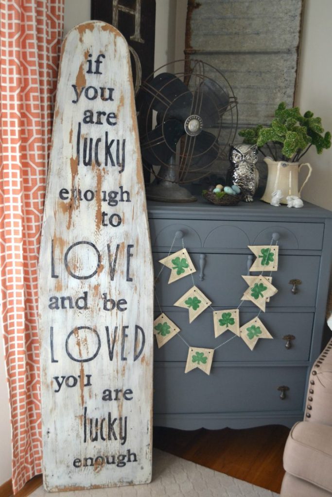 A wood sign can come in all shapes, sizes and colors. They can also come with all kinds of words. I repurposed an antique ironing board to create this wood sign to remind us what is important. Click over to see how easy it is to make!