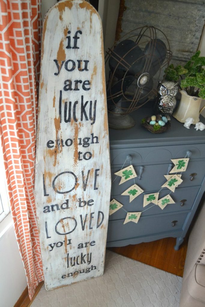 A wood sign can come in all shapes, sizes and colors. They can also come with all kinds of words. I repurposed an antique ironing board to create this wood sign to remind us what is important. Click over to see how easy it is to make!