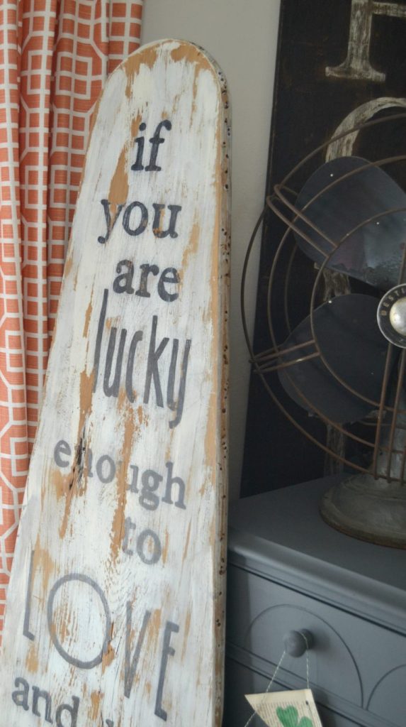 A wood sign can come in all shapes, sizes and colors. They can also come with all kinds of words. I repurposed an antique ironing board to create this wood sign to remind us what is important. Click over to see how easy it is to make!