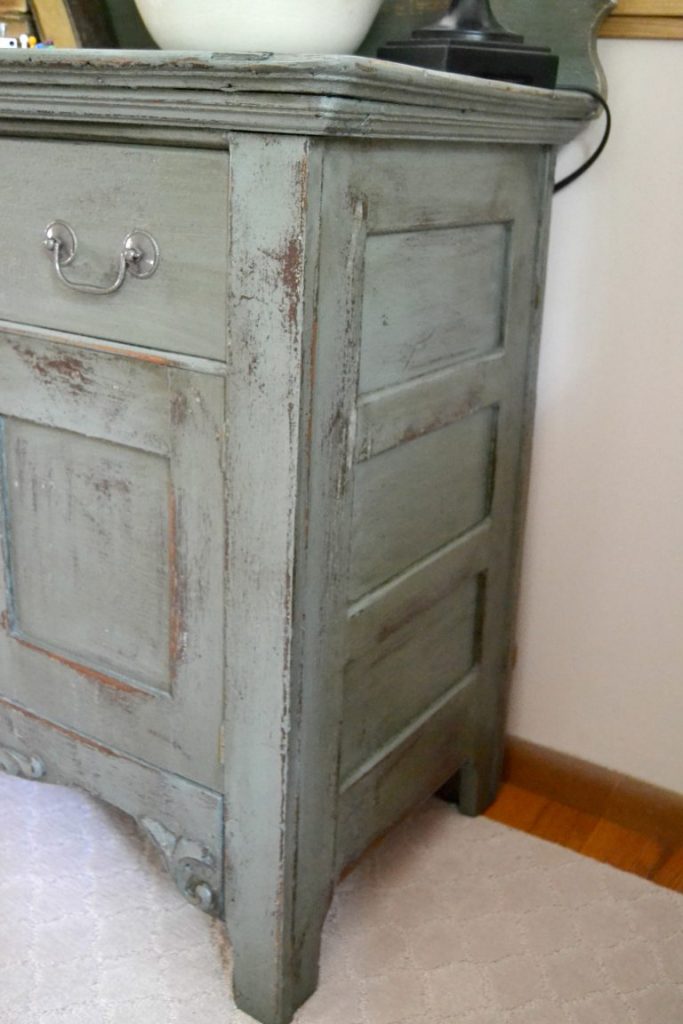 Even a wooden chest of drawers left in a garage for a long time deserves a makeover. Click over to see how I transformed this wooden chest of drawers with a technique of stain over paint. 