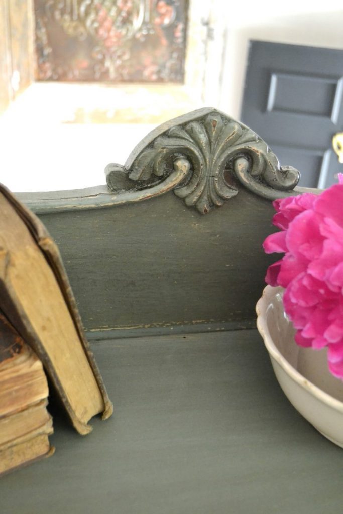 Even a wooden chest of drawers left in a garage for a long time deserves a makeover. Click over to see how I transformed this wooden chest of drawers with a technique of stain over paint. 