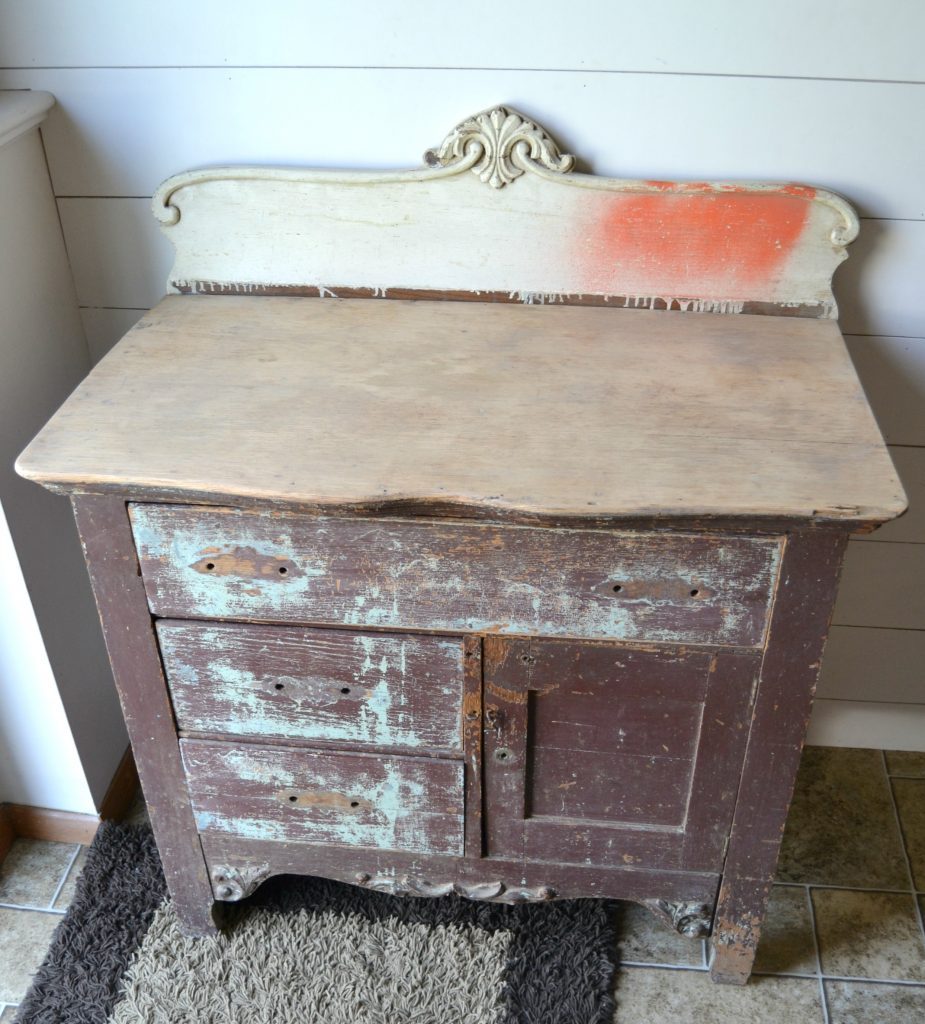 Even a wooden chest of drawers left in a garage for a long time deserves a makeover. Click over to see how I transformed this wooden chest of drawers with a technique of stain over paint. 