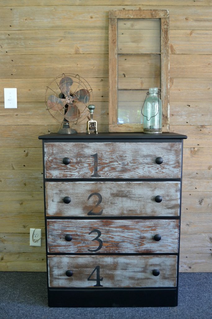 Do you love rustic touches in home decor, but don't want to spend a lot of money to get it? Click over and find this easy rustic dresser makeover that was done with stain and paint. 