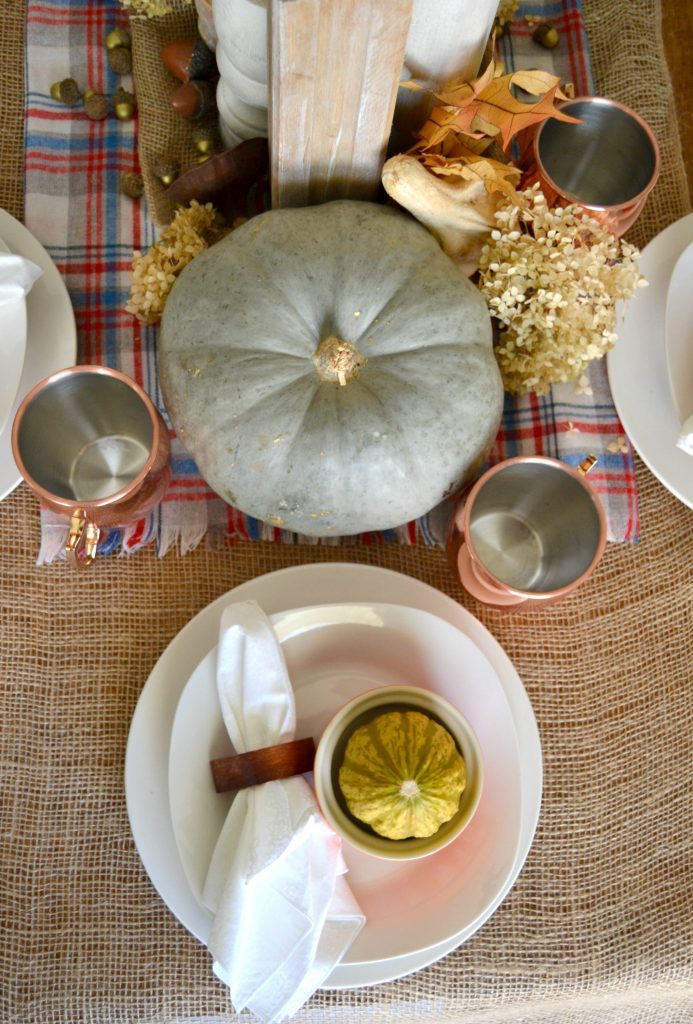 The fall season is full of gatherings for family and friends and this easy fall tablescape was made possible with a burlap table runner, some plaid fabric and natural elements. Click over to get the details on how to set this table in your home. 