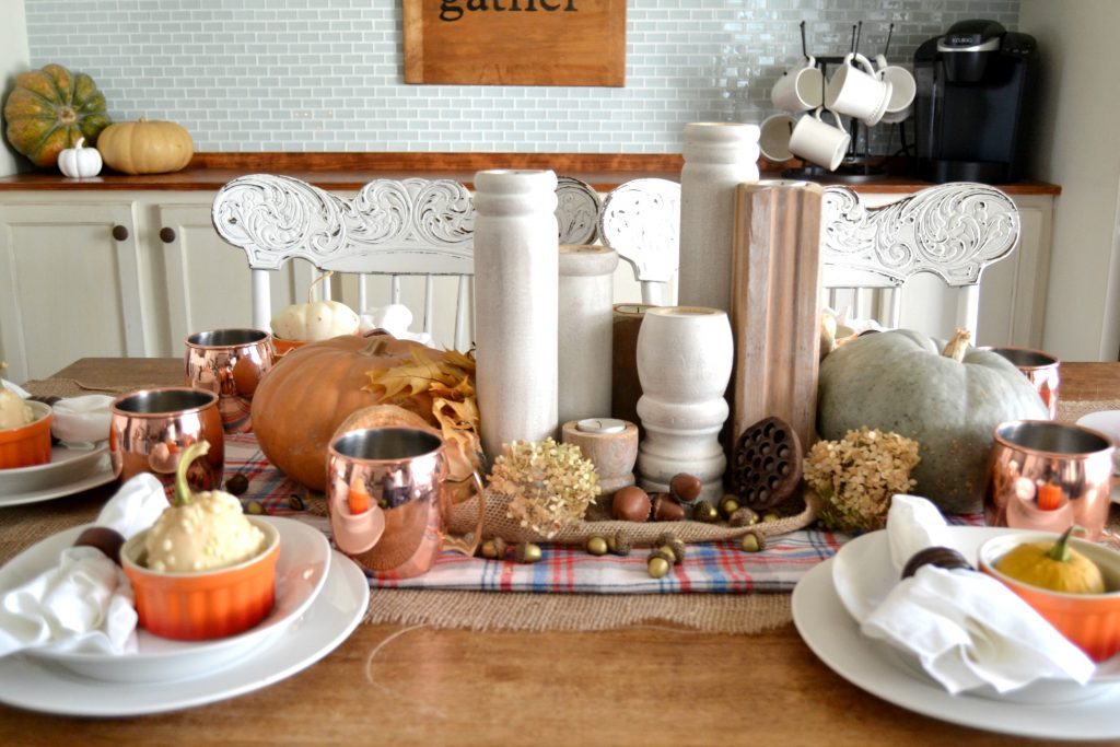 The fall season is full of gatherings for family and friends and this easy fall tablescape was made possible with a burlap table runner, some plaid fabric and natural elements. Click over to get the details on how to set this table in your home. 