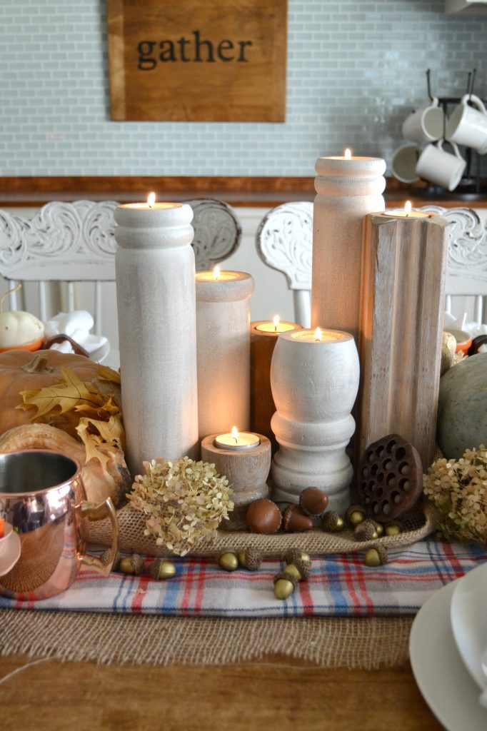 The fall season is full of gatherings for family and friends and this easy fall tablescape was made possible with a burlap table runner, some plaid fabric and natural elements. Click over to get the details on how to set this table in your home. 