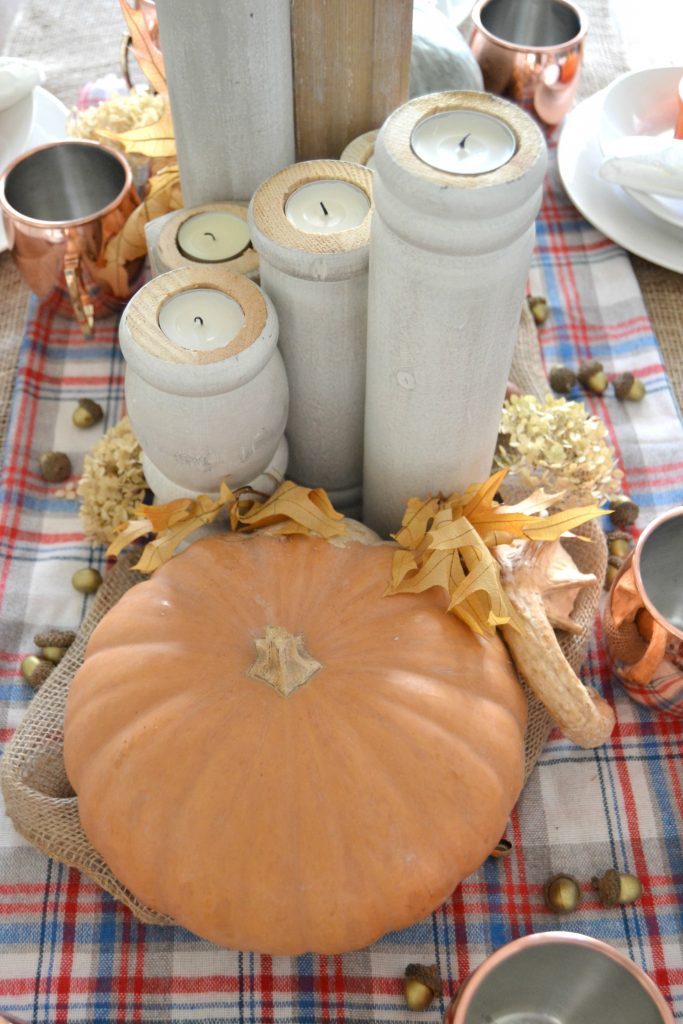 The fall season is full of gatherings for family and friends and this easy fall tablescape was made possible with a burlap table runner, some plaid fabric and natural elements. Click over to get the details on how to set this table in your home. 