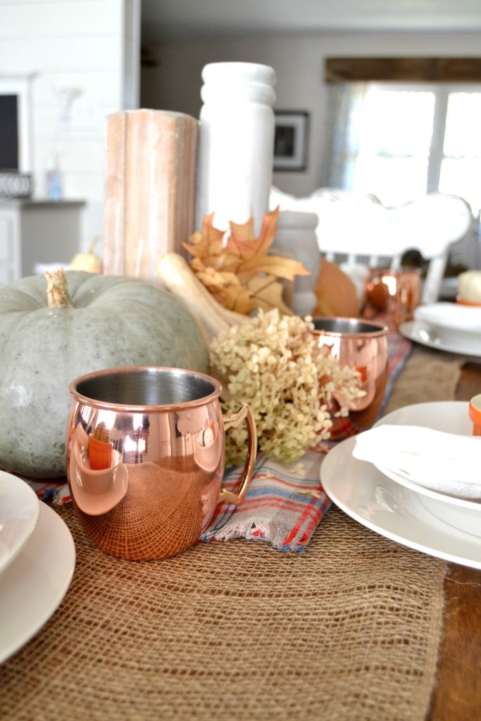 The fall season is full of gatherings for family and friends and this easy fall tablescape was made possible with a burlap table runner, some plaid fabric and natural elements. Click over to get the details on how to set this table in your home. 