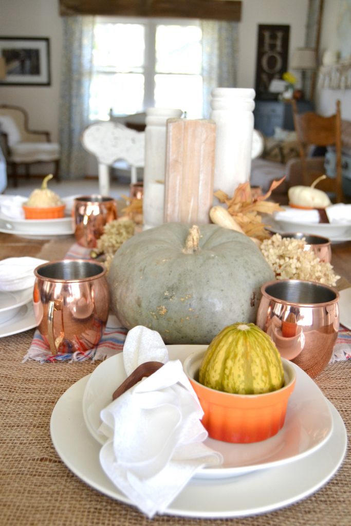 The fall season is full of gatherings for family and friends and this easy fall tablescape was made possible with a burlap table runner, some plaid fabric and natural elements. Click over to get the details on how to set this table in your home. 