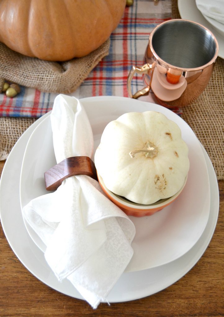 The fall season is full of gatherings for family and friends and this easy fall tablescape was made possible with a burlap table runner, some plaid fabric and natural elements. Click over to get the details on how to set this table in your home. 