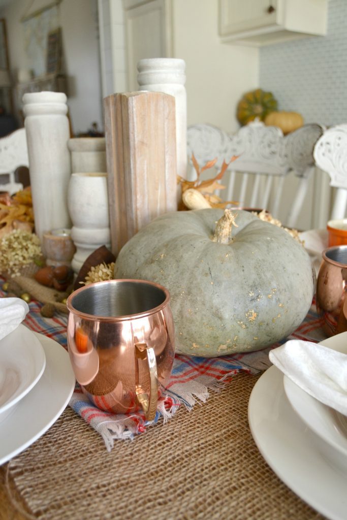 The fall season is full of gatherings for family and friends and this easy fall tablescape was made possible with a burlap table runner, some plaid fabric and natural elements. Click over to get the details on how to set this table in your home. 