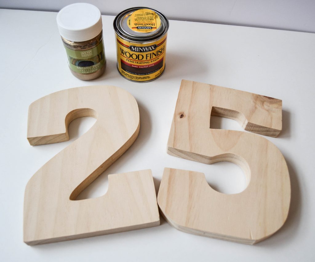 DIY Bookends - Looking for some fun bookends that don't cost a ton of money? These Gold Dipped Number DIY Bookends are easy to make and make a statement wherever you place them.