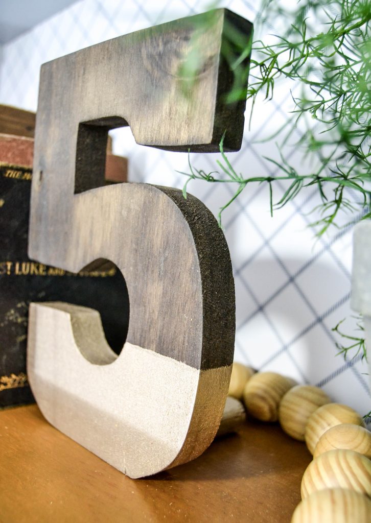 DIY Bookends - Looking for some fun bookends that don't cost a ton of money? These Gold Dipped Number DIY Bookends are easy to make and make a statement wherever you place them.