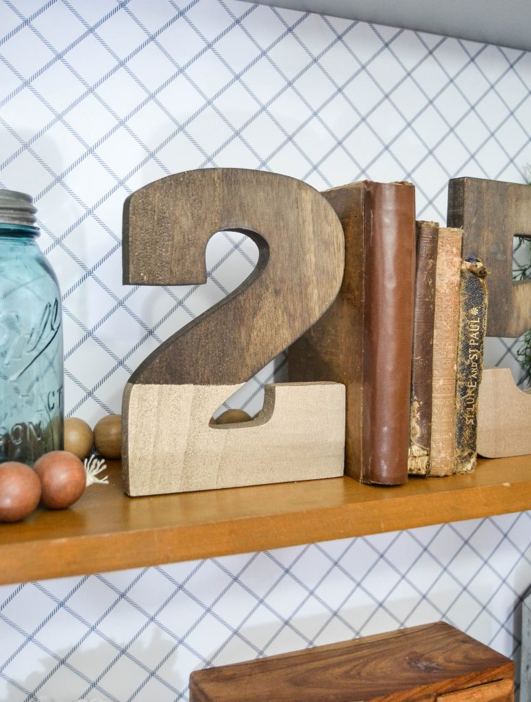 DIY Bookends - Looking for some fun bookends that don't cost a ton of money? These Gold Dipped Number DIY Bookends are easy to make and make a statement wherever you place them.