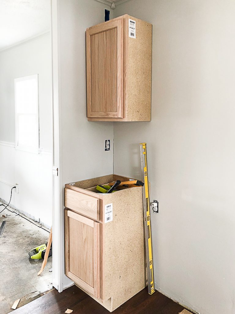 If you are thinking about adding unfinished wood cabinets to your home or a flip house, click over to see how we added them to our third project and what a difference they made to the kitchen.