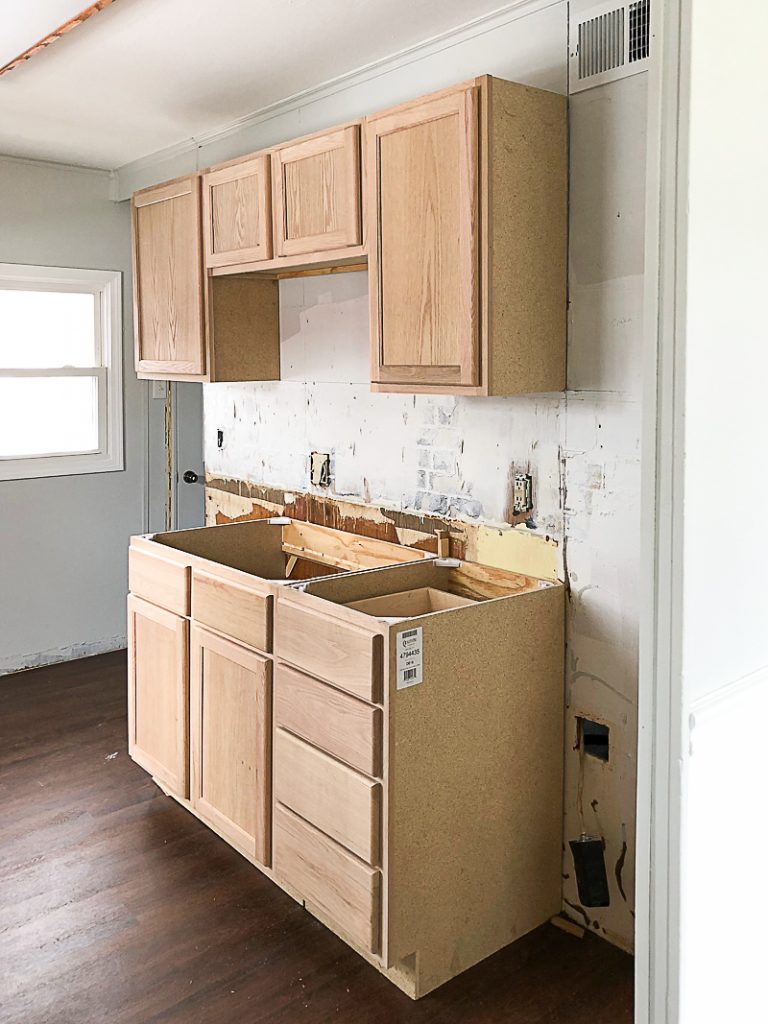 If you are thinking about adding unfinished wood cabinets to your home or a flip house, click over to see how we added them to our third project and what a difference they made to the kitchen.