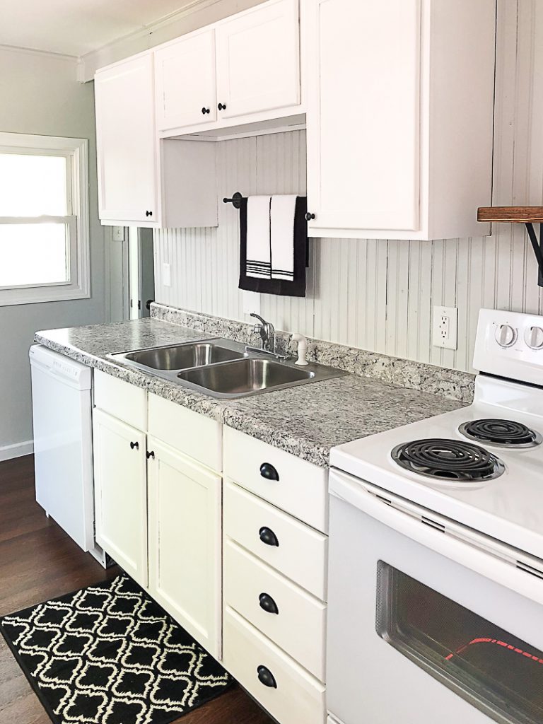 If you are thinking about adding unfinished wood cabinets to your home or a flip house, click over to see how we added them to our third project and what a difference they made to the kitchen.