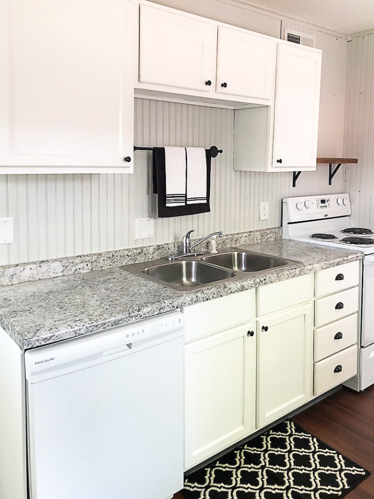 If you are thinking about adding unfinished wood cabinets to your home or a flip house, click over to see how we added them to our third project and what a difference they made to the kitchen.