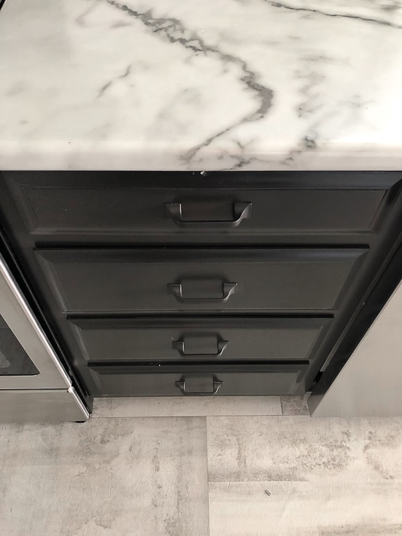 Looking for cabinet pulls for your kitchen? This post will show you how black cabinet pulls transformed the flip house kitchen.