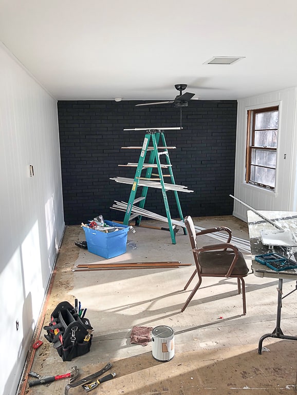 The brick room makeover in the flip house made a huge difference in the space. Click over to see the easy steps we took to make this room look brand new!