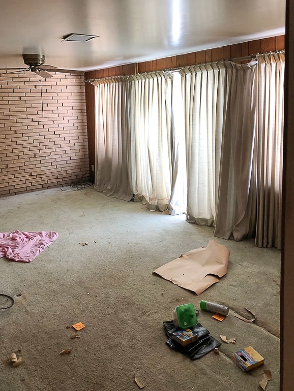 The brick room makeover in the flip house made a huge difference in the space. Click over to see the easy steps we took to make this room look brand new!