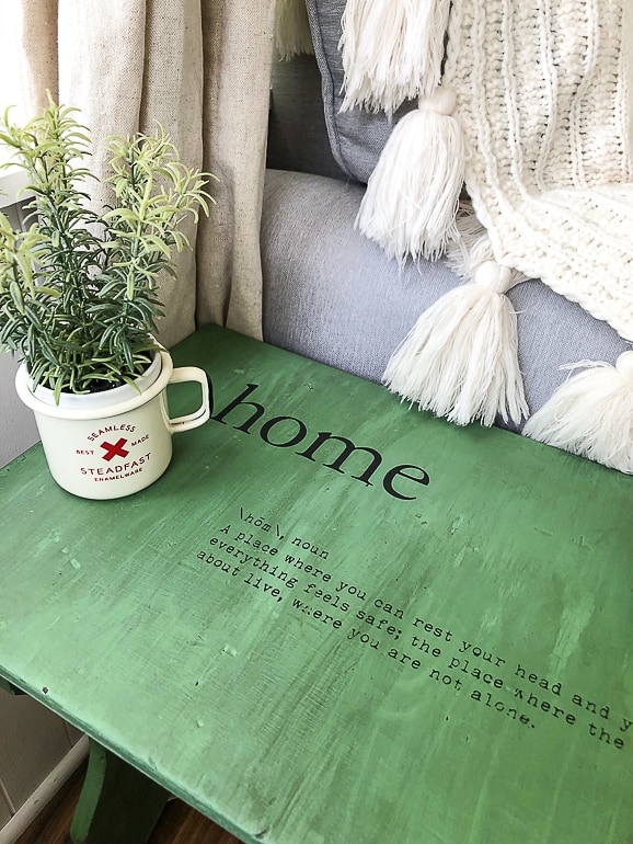 This yard sale find became a cute green bench though an easy makeover. A little paint, glaze and a surprise inside make this bench a fun piece for any room.
