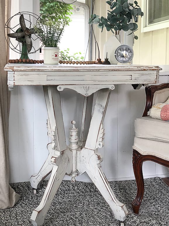 If you like the look of painted antique furniture, but want to save money to have it, this post will show you how to paint and distress a wood table in a few, easy steps.