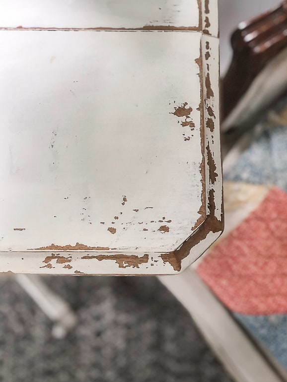 If you like the look of painted antique furniture, but want to save money to have it, this post will show you how to paint and distress a wood table in a few, easy steps.