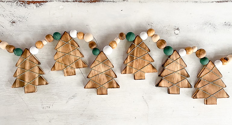 This DIY Wood Burned Christmas Tree Garland takes some common craft items and turns them into charming decor for the Christmas season.