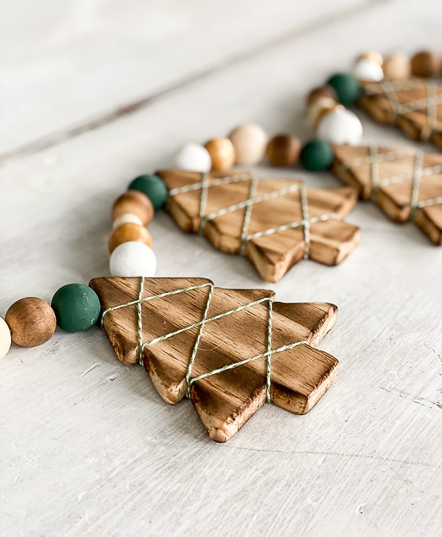 This DIY Wood Burned Christmas Tree Garland takes some common craft items and turns them into charming decor for the Christmas season.