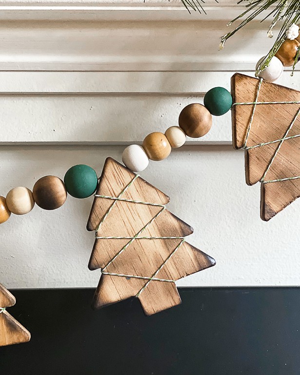 This DIY Wood Burned Christmas Tree Garland takes some common craft items and turns them into charming decor for the Christmas season.