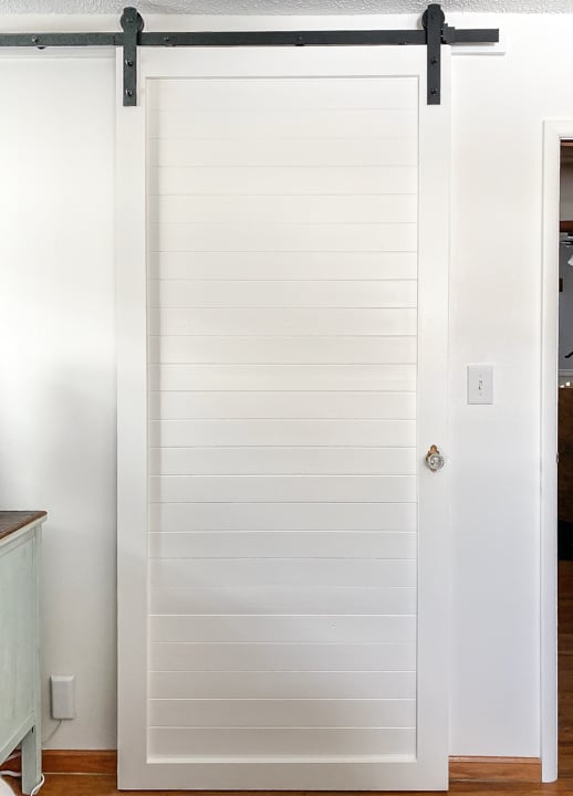 If you are looking for a new closet door, but don't want to spend a lot of money, check out this tutorial for a DIY Closet Door With Sliding Door Hardware.