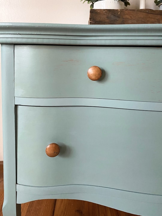 This Bird's Eye Maple Dresser Makeover tutorial shows you how to brings life to an old piece in a big way with some cleaning, a fun paint color and wax!