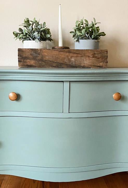 This Bird's Eye Maple Dresser Makeover tutorial shows you how to brings life to an old piece in a big way with some cleaning, a fun paint color and wax!