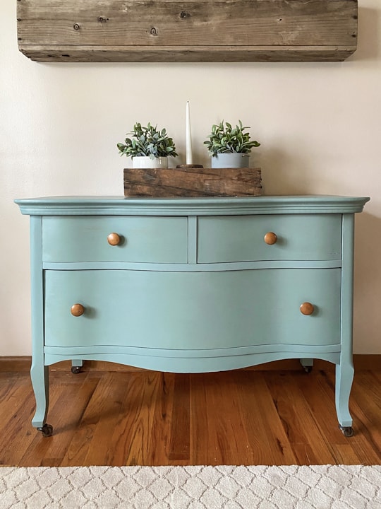 This Bird's Eye Maple Dresser Makeover tutorial shows you how to brings life to an old piece in a big way with some cleaning, a fun paint color and wax!