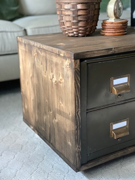 Create a DIY Industrial Coffee Table from an industrial metal drawer piece, some wood, stain and old casters to get the look you want for less!