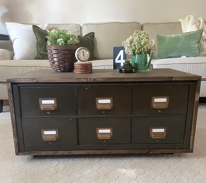 Create a DIY Industrial Coffee Table from an industrial metal drawer piece, some wood, stain and old casters to get the look you want for less!