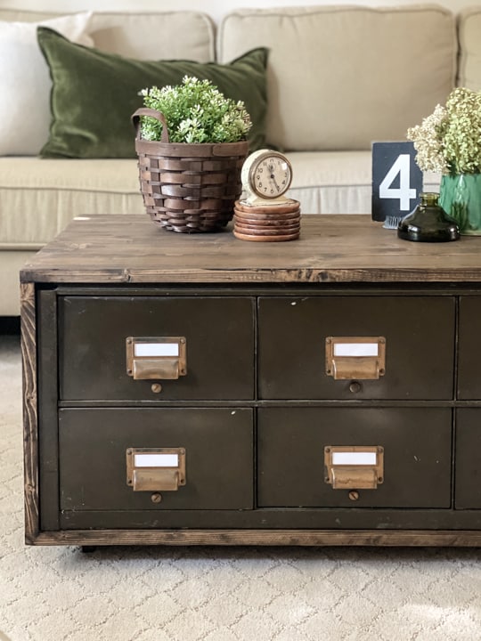 Create a DIY Industrial Coffee Table from an industrial metal drawer piece, some wood, stain and old casters to get the look you want for less!