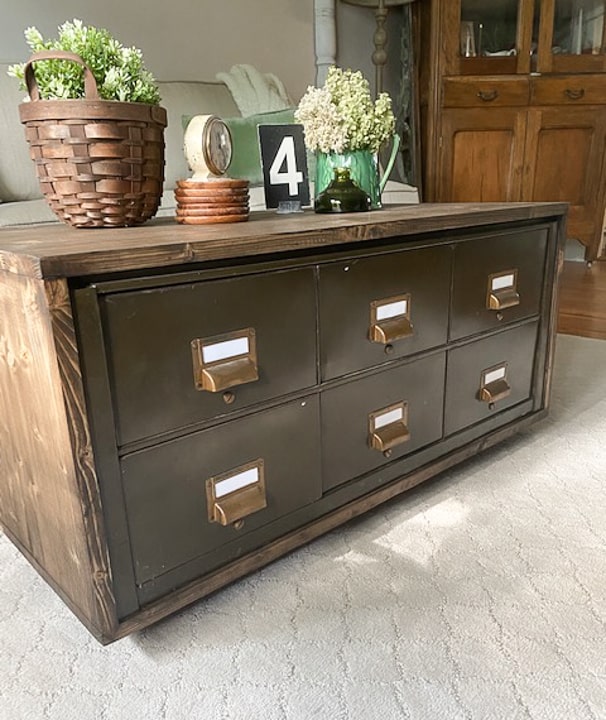 Create a DIY Industrial Coffee Table from an industrial metal drawer piece, some wood, stain and old casters to get the look you want for less!